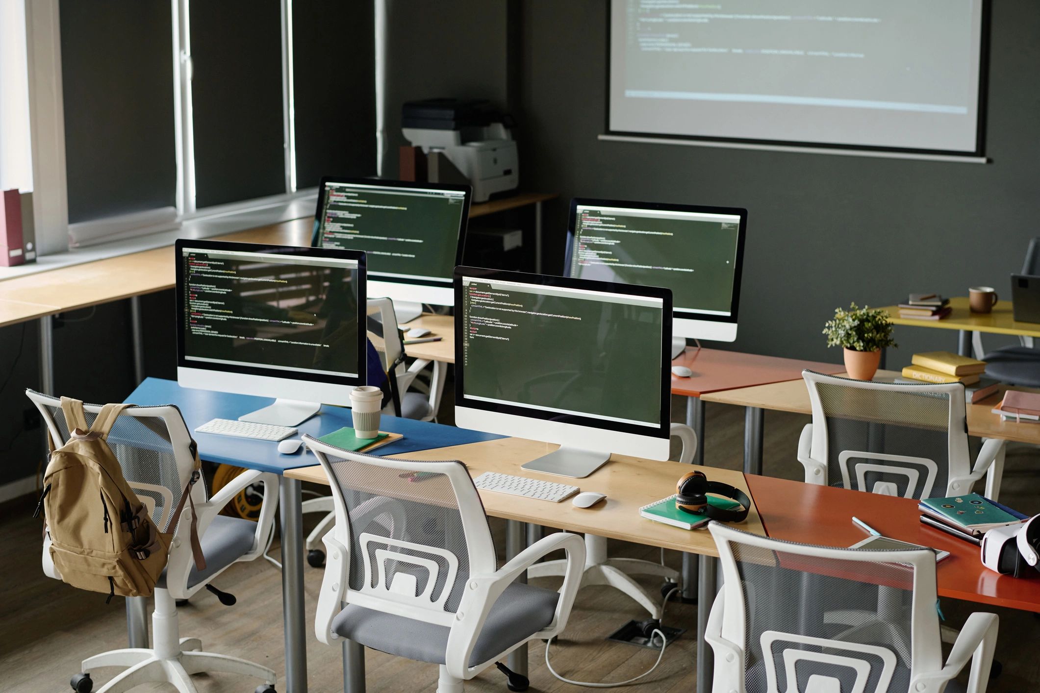 Modern IT workspace with computer screens and code
